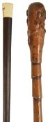 An ebonised Swagger stick, with ivory knop and a walking cane with knotted ridges, (2)swagger