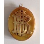 A Victorian oval hinged pendant picture locket, circa 1880the front set with raised monogram and
