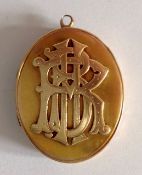 A Victorian oval hinged pendant picture locket, circa 1880the front set with raised monogram and