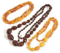 Two graduated butterscotch amber bead necklaces,together with a long graduated and facetted