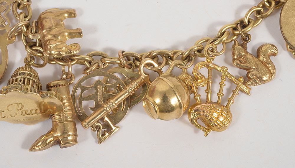 A selection of mainly 9ct gold and yellow metal charms suspended from a gilded metal bracelet, 9ct - Image 4 of 4