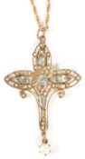 An Edwardian gold mounted aquamarine and pearl scroll pendant cross the pierced 9ct gold cross set