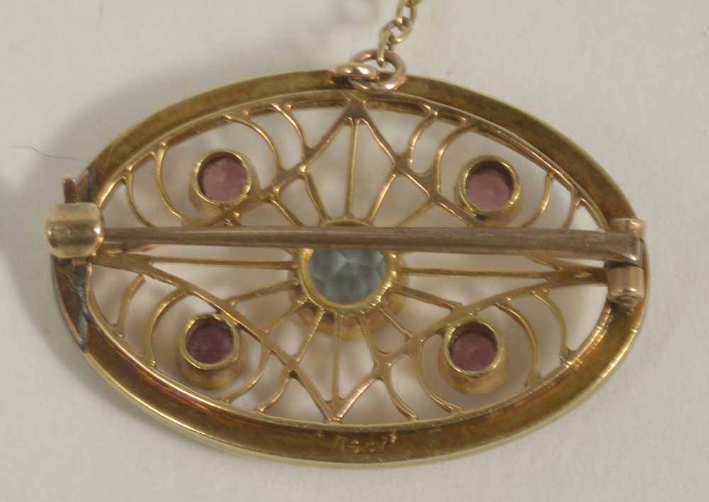 A delicate Edwardian 15ct. gold seed pearl and gem set scroll brooch,the oval brooch set with four - Image 2 of 2
