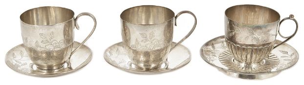 A pair of early 20th century Chinese silver European style tea cups and saucers and a single