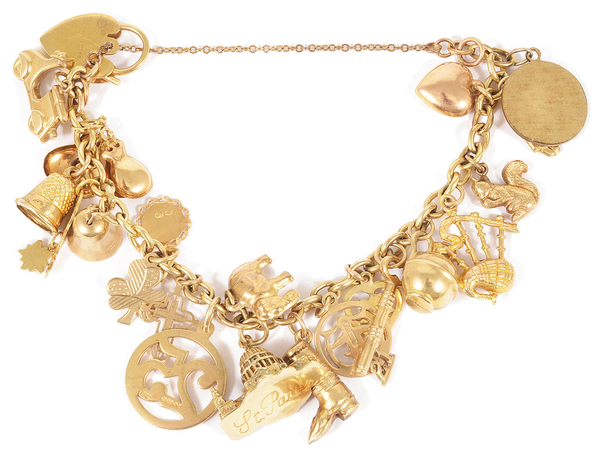 A selection of mainly 9ct gold and yellow metal charms suspended from a gilded metal bracelet, 9ct