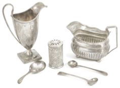 Two silver cream jugs, pepperette and condiment spoonscomprising a George III cream jug, London