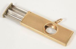 A 9ct gold cigar cutter, Birmingham 1987of rectangular form with engine turned decoration,