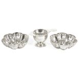 A pair of silver pierced bon bon dishes and a silver tea strainer,the hexagonal lobed pierced bon
