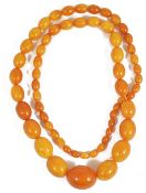 A butterscotch amber graduated oval bead necklace,approximate total weight 84.1 gm.approx. weight