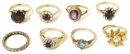 A collection of gold mounted contemporary dress ringsto include an amethyst and opal circular