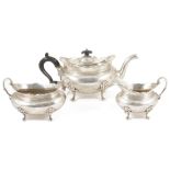 An Edwardian three piece silver tea service, Sheffield 1919the teapot with ebonised finial and