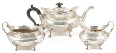 An Edwardian three piece silver tea service, Sheffield 1919the teapot with ebonised finial and