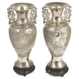 A pair of twin handled Chinese export silver vases, circa 1910the baluster bodies decorated in