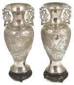 A pair of twin handled Chinese export silver vases, circa 1910the baluster bodies decorated in