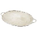 An impressive George V silver twin handle tray, Sheffield 1919of oval pie crust from with two shaped