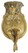 An amusing Victorian brass gas wall cigar lighter, formed as a jester smoking a cigar, push action