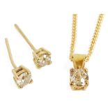 A small contemporary diamond set pendant and matching diamond ear studs,the yellow metal pendant,