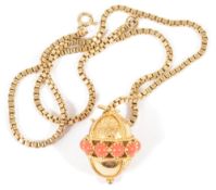 A contemporary gold and coral set pendant on chainthe yellow metal orb pierced with central row of