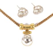 A contemporary 18ct gold pendant on chain and diamond set earringsthe pendant of yellow and white