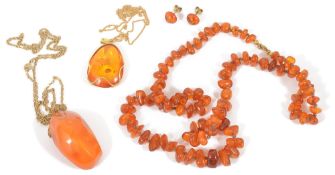 A large natural amber pendant and other amber jewellerythe large natural amber pendant of