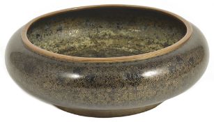 An early 20th century shallow Chinese cloisonn‚ bowl,the black ground with intricate coil foliate