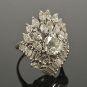 A large pear shaped diamond set fancy cocktail cluster ringthe central pear shaped diamond