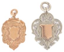 An Edwardian 9ct gold medallion watch chain fob the scroll edged, shield shaped medallion with