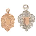 An Edwardian 9ct gold medallion watch chain fob the scroll edged, shield shaped medallion with