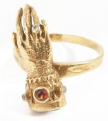 An unusual Victorian style jewelled hand ringthe 9ct gold ring formed as a hand with garnet set cuff