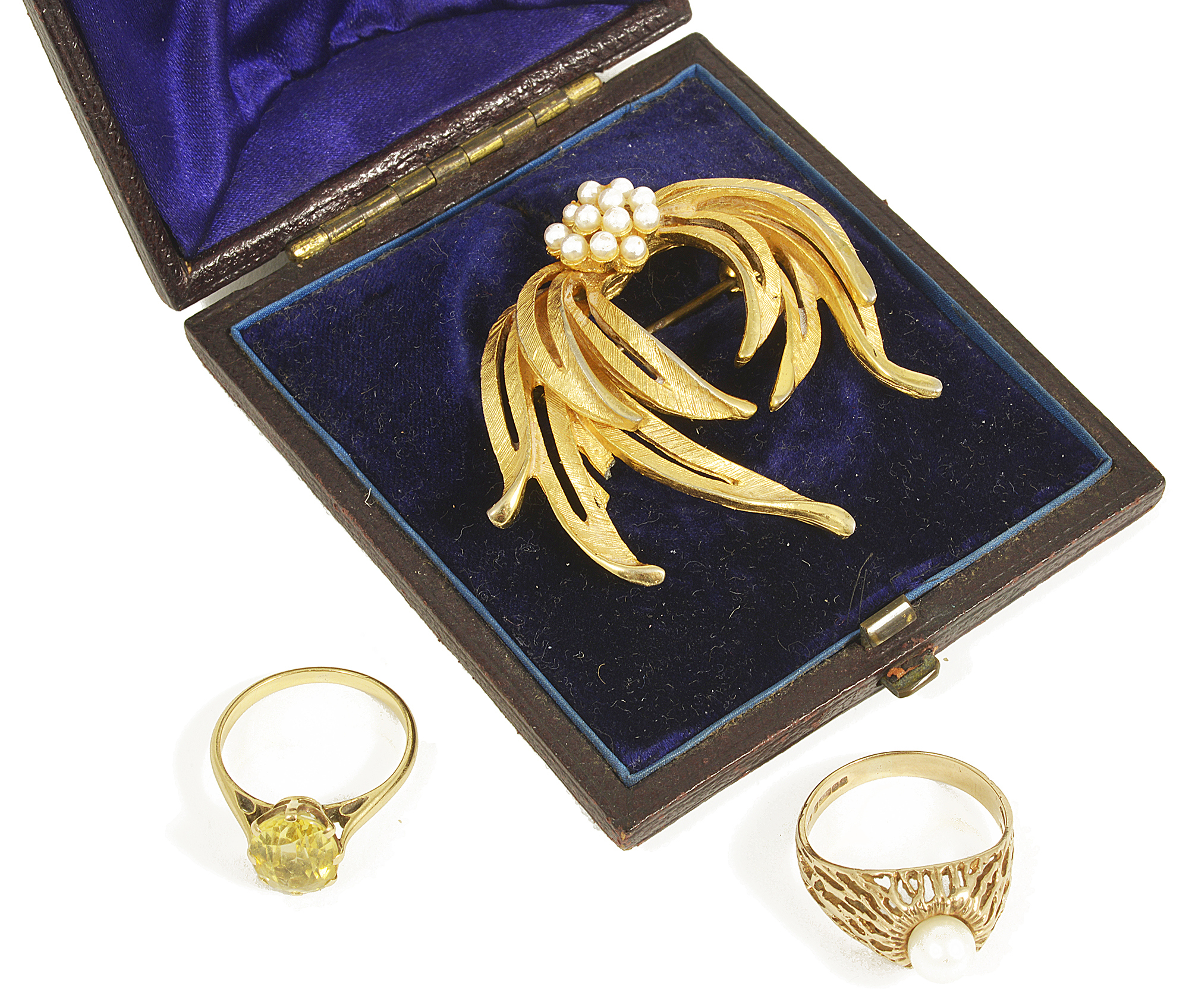 An oval yellow gem set dress ring and a pearl set ringthe oval facetted gem mounted in a yellow