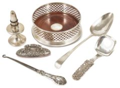 A selection of silver, bottle coaster, bottle stopper, spoons, button hookthe Mappin & Webb circular