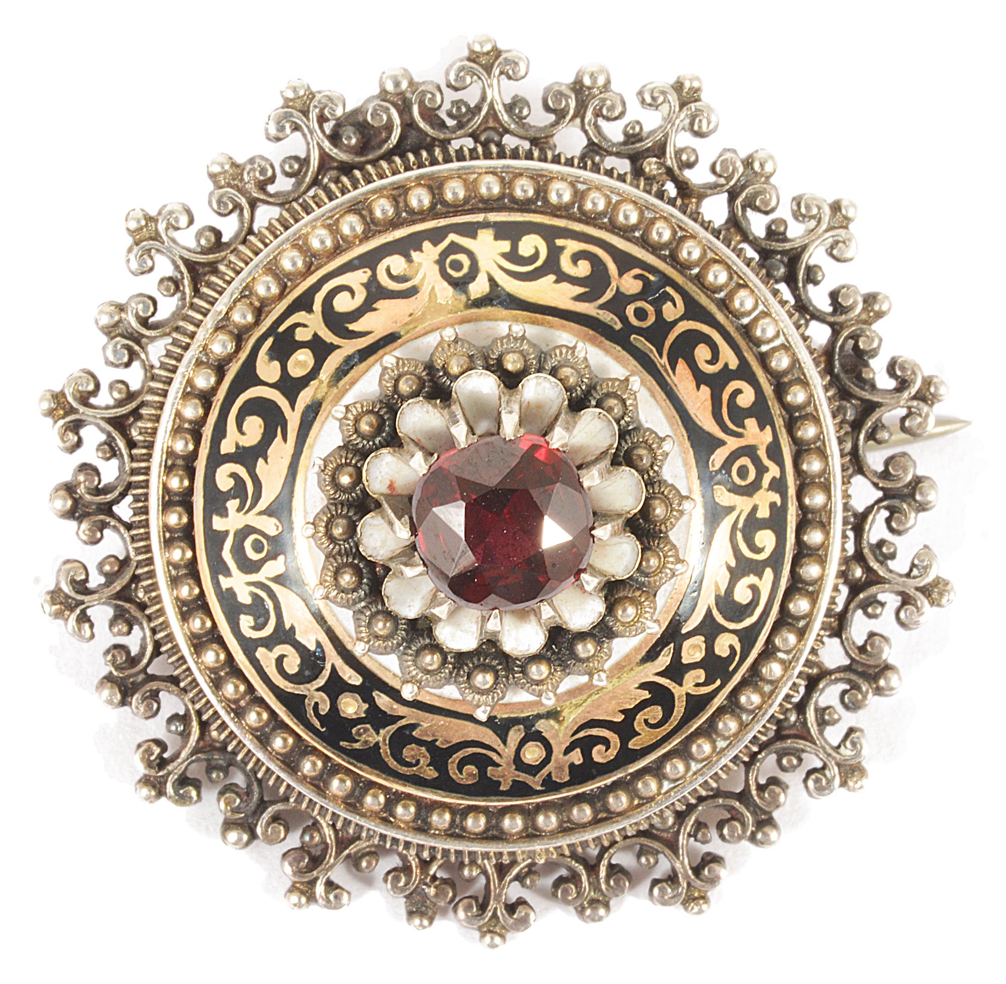 A late 19th Century Austro-Hungarian garnet and enamel broochthe circular target brooch raised