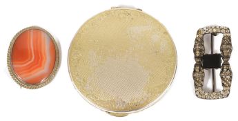 A circular silver compact, London 1961 by Kigu Ltd, the hinged cover with inset mirror and the