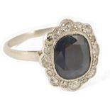 An attractive Edwardian sapphire and diamond cluster ringthe dark blue sapphire mounted in a