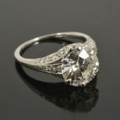 A 3.00 ct diamond set ring, circa 1940the diamond set in a fancy diamond set scroll mount, having