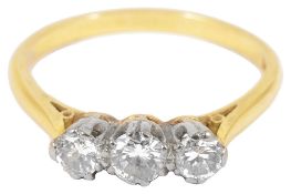 An 18ct. gold mounted three stone diamond set ringthe centre stone approx. 0.20 ct. with smaller