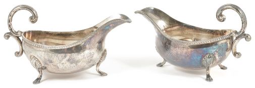 Two silver sauce boats, London 1966of typical form with rope edge, scrolled handle upon pad