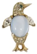 An amusing silver gilt and paste set penguin brooch, circa 1950having faux moonstone 'jelly
