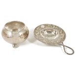 An early 20th century Chinese export silver tea strainer and bowlthe strainer with repousse