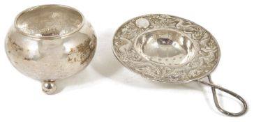 An early 20th century Chinese export silver tea strainer and bowlthe strainer with repousse