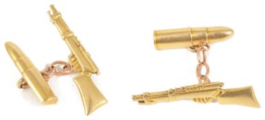 A pair of unusual yellow metal 'bullet and rifle' cufflinkschain linked and with bullet to one