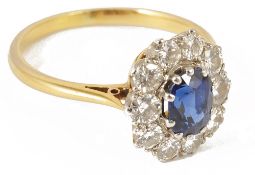 An attractive oval diamond set cluster ring,with central oval blue gem stone set within a