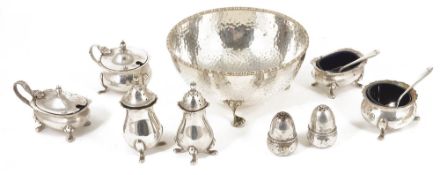 A collection of assorted silver plated cruets and bowlcomprising two hinge lidded mustard containers