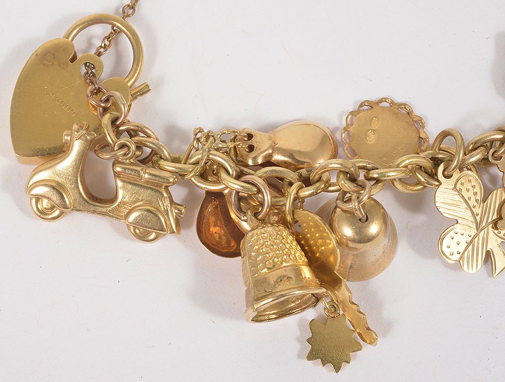 A selection of mainly 9ct gold and yellow metal charms suspended from a gilded metal bracelet, 9ct - Image 2 of 4