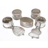 A collection silver napkin rings and decanter labels