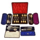 A collection of five cases of silver flat wear including teaspoons and christening sets