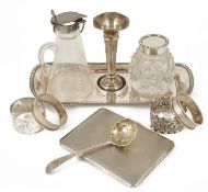 A collection of silver, napkin rings, cigarette case, bud vase, glass inkwell and jug