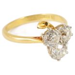 An attractive Edwardian three stone diamond set 'clover leaf 'ring