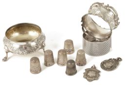 A collection of silver salt napkins rings, thimbles and medals