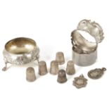 A collection of silver salt napkins rings, thimbles and medals